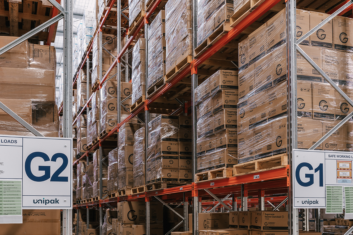 Warehouse Aisles showcasing unipak products featuring the green choice brand in cardboard cartons.
