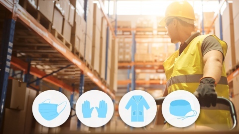 safety icons in front of a warehouse worker wearing PPE gear pulling a hand trolley