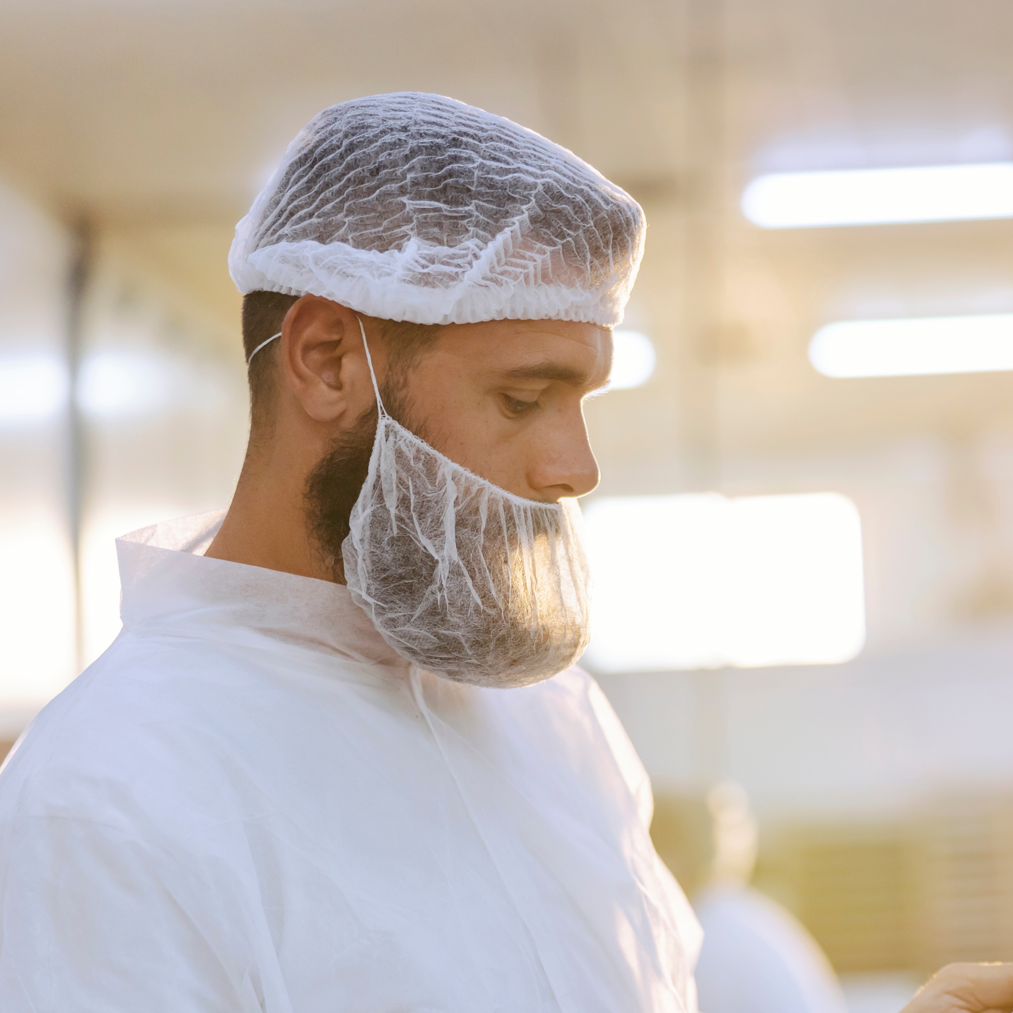 man wearing single loop beard protector and clip hat