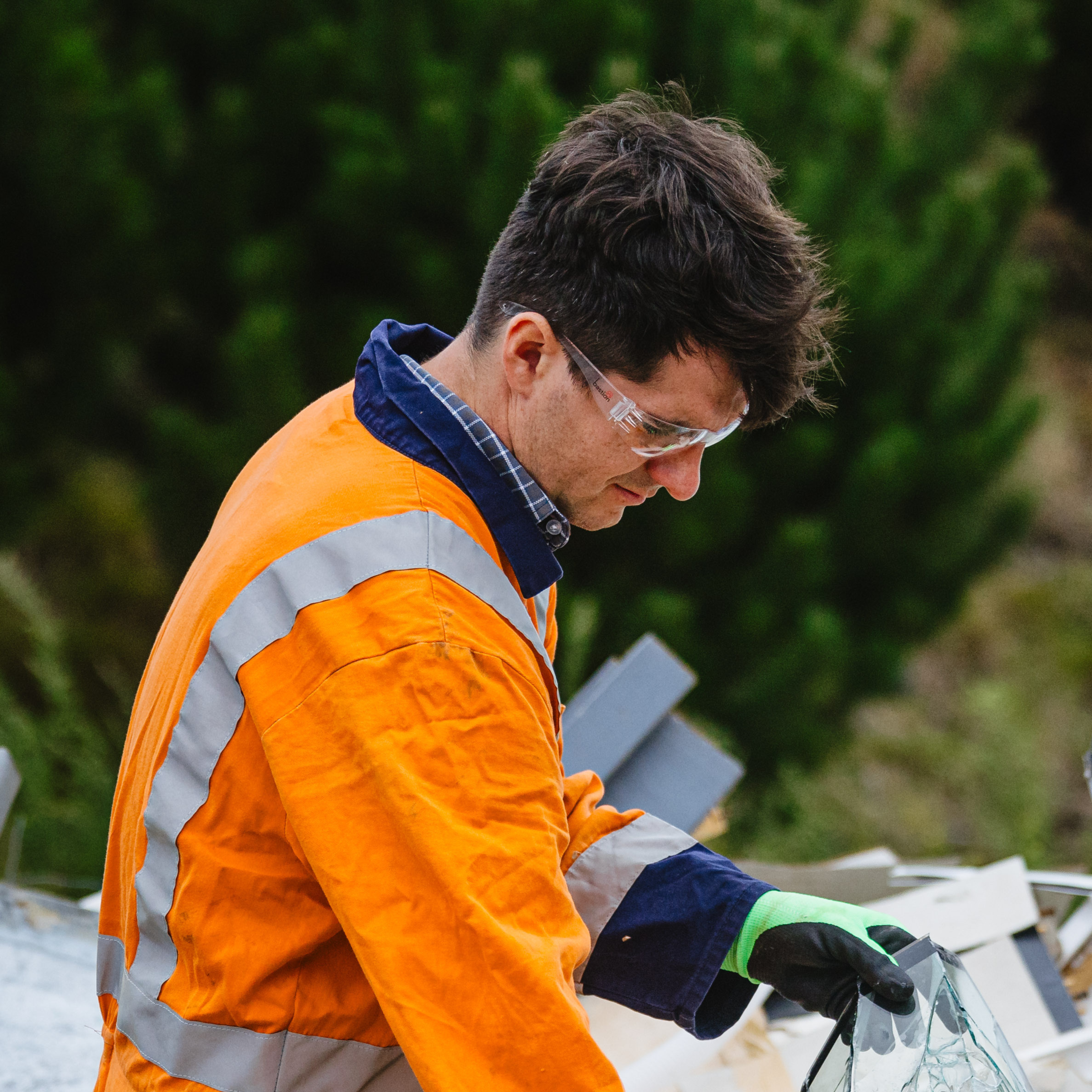 person wearing safety glasses and work gloves