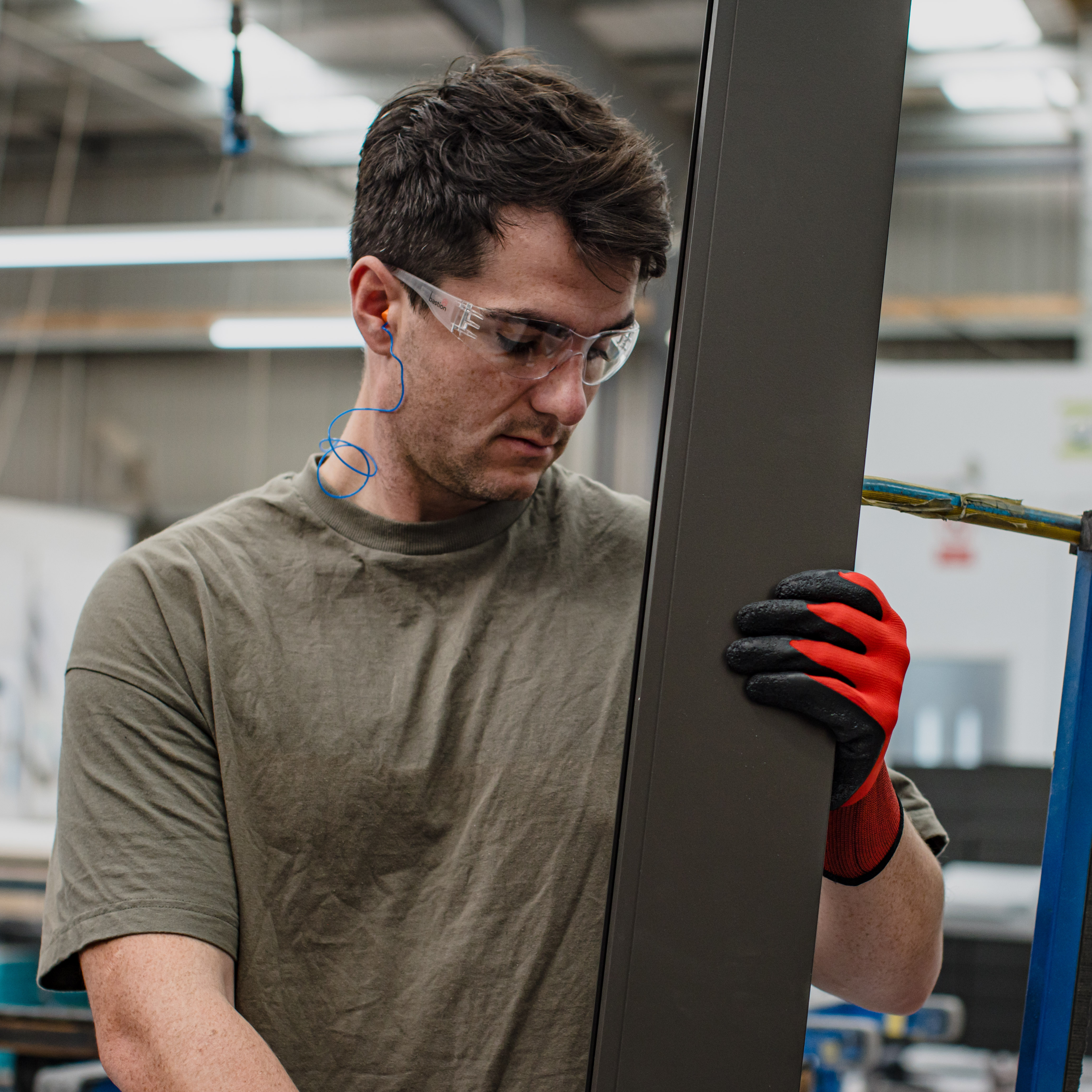 person wearing safety glasses and work gloves