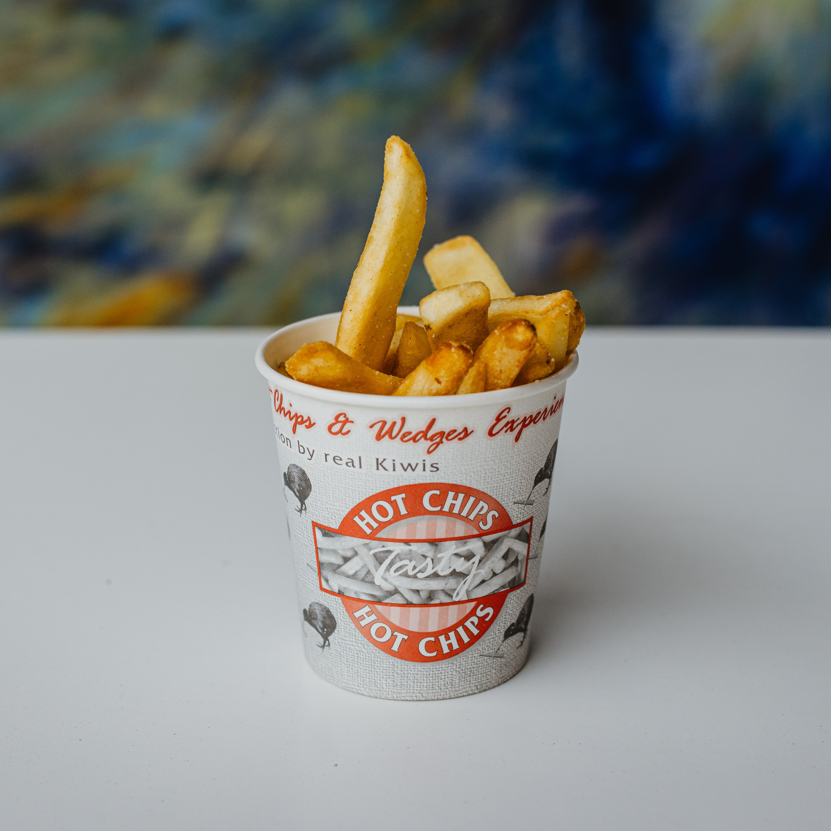 Emperor Hot Chip Cup filled with hot chips sitting on a table