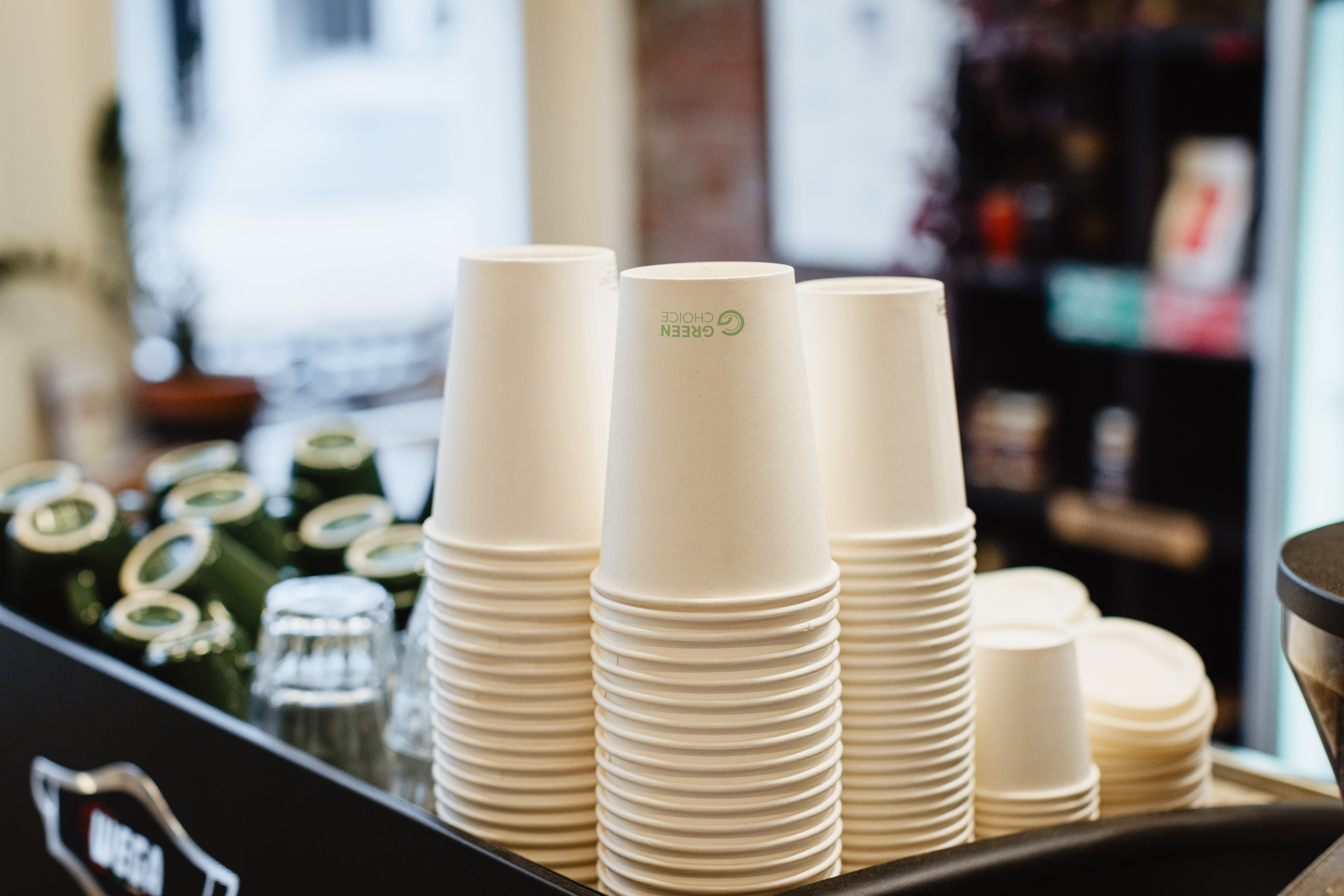 Green Choice single wall cups on display at top of coffee machine