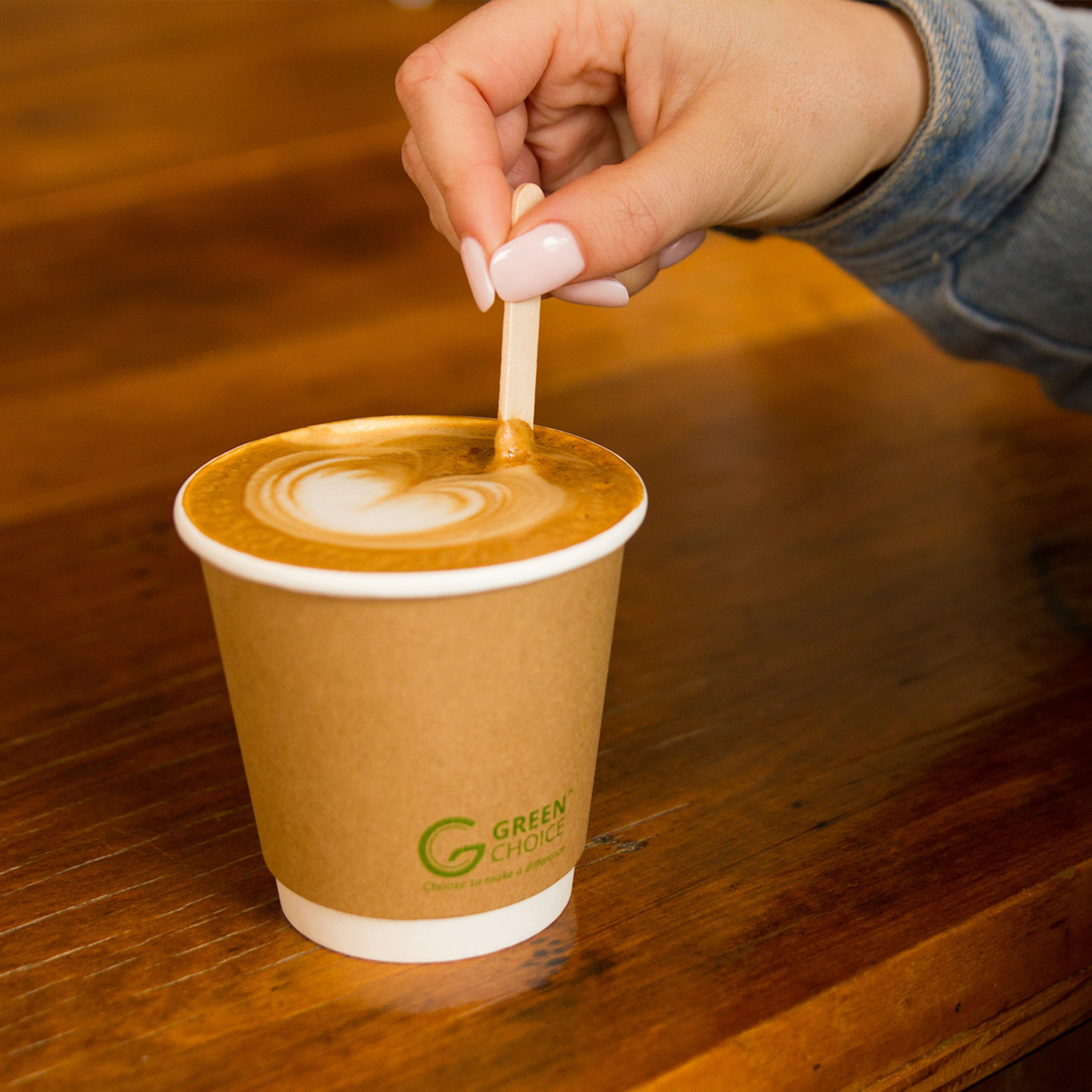 Coffee in a Green Choice Double wall coffee cup being stirred with a Green Choice Stir Stick